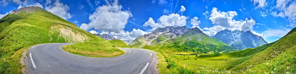 Panoramic photo of a road in the French Alps.
