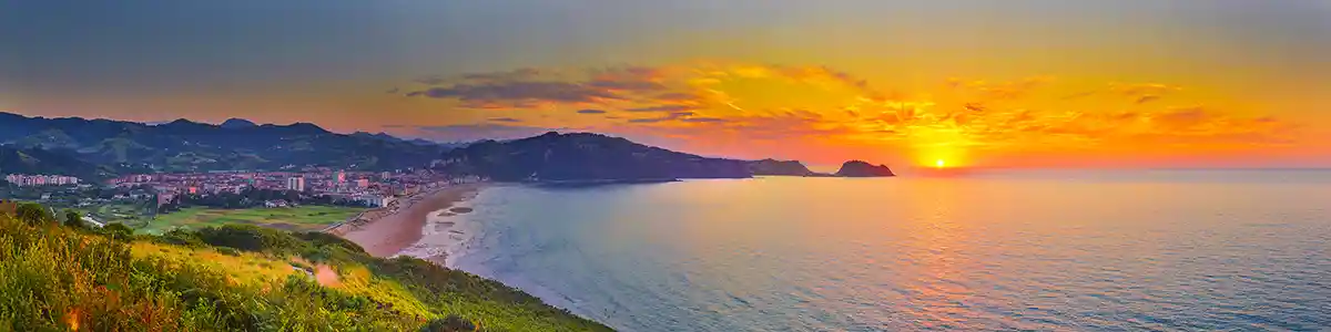 Panoramic photo of summer sunset over the Atlantic Ocean in Spain.