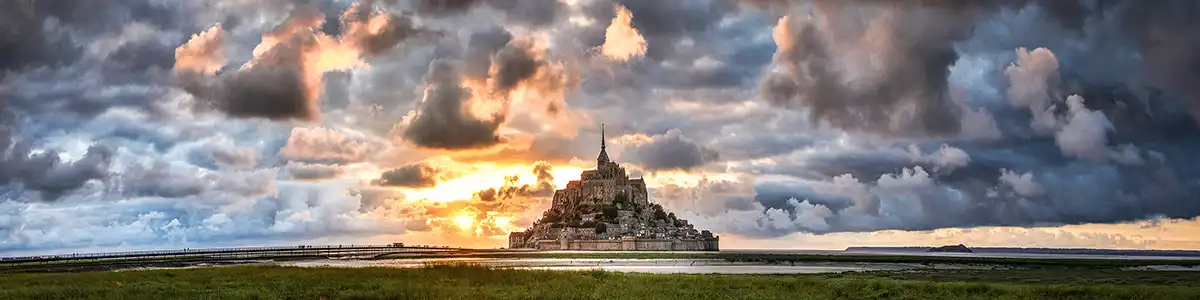 Panoramic photo of sunset Mont-Saint-Michel in France.
