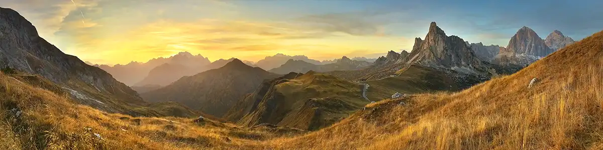 Panoramic photo of sunset mountain pass Ra Gusela in the Dolomites.